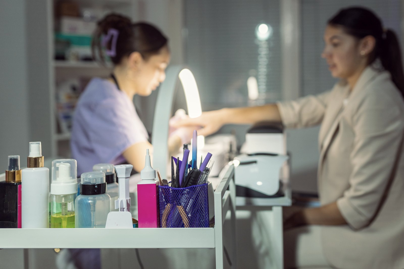 Client receiving a manicure at a salon table