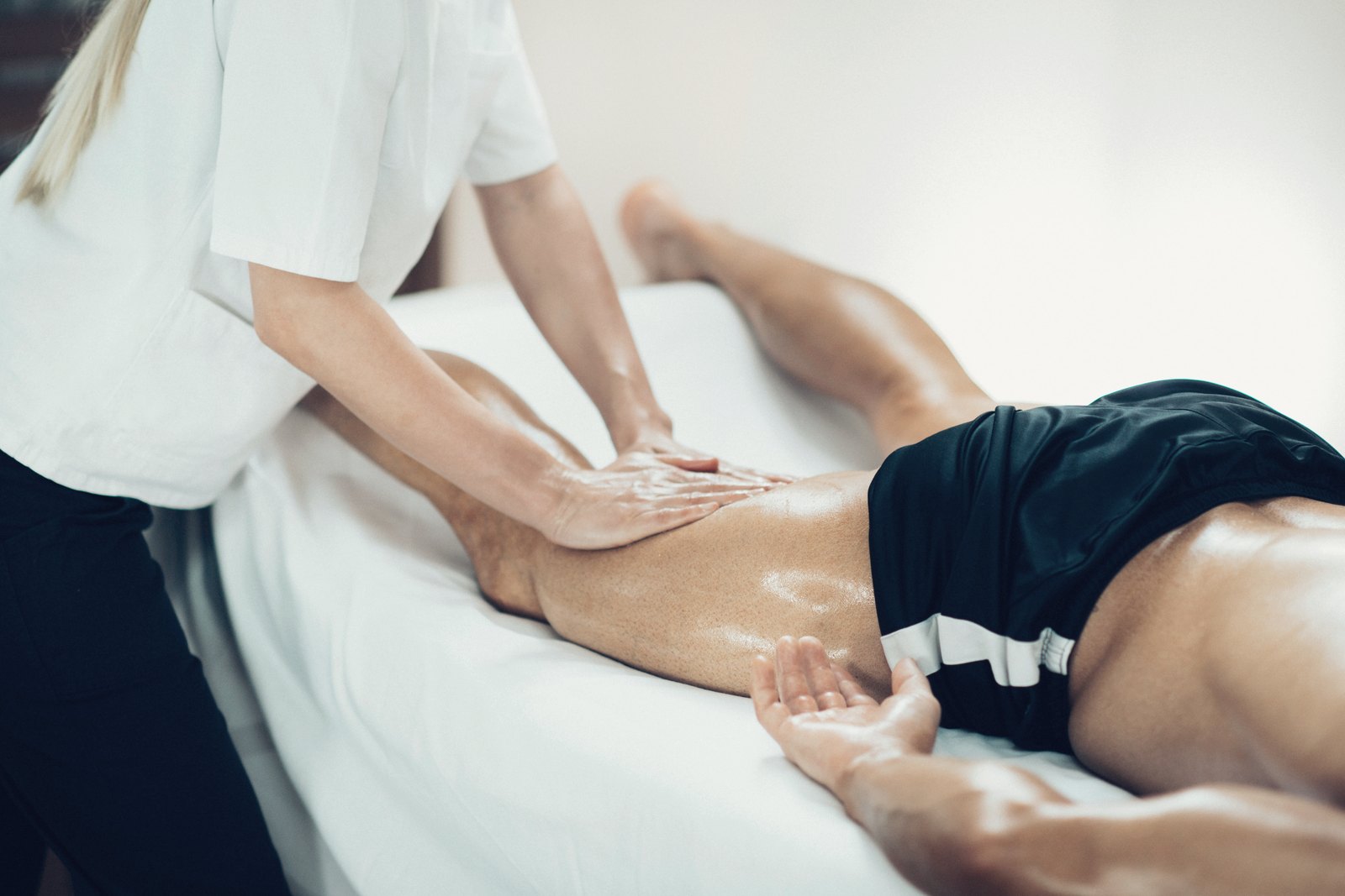 Therapist working a client's leg during a clinic massage session
