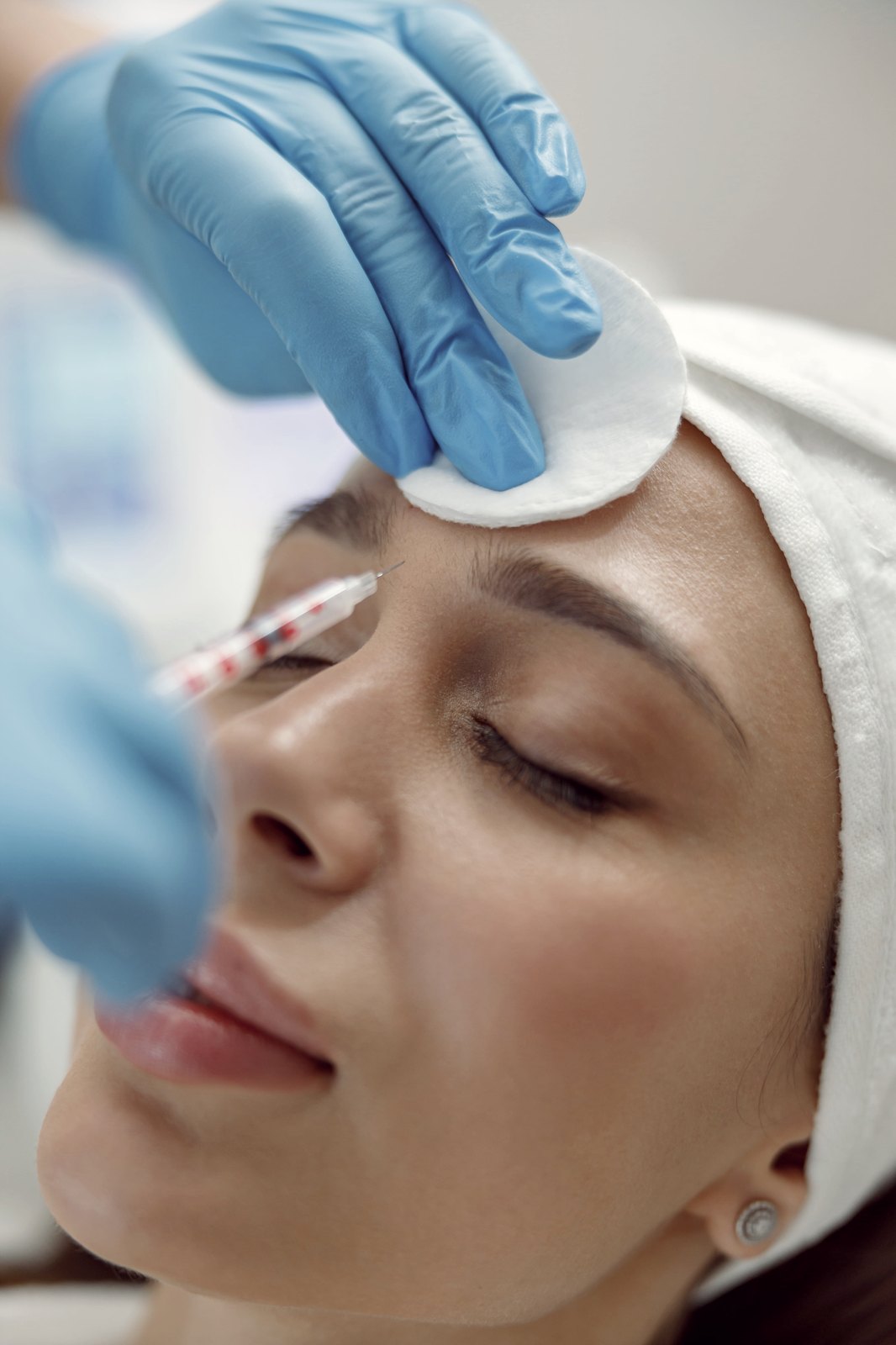 Practitioner giving a facial injection in a beauty clinic